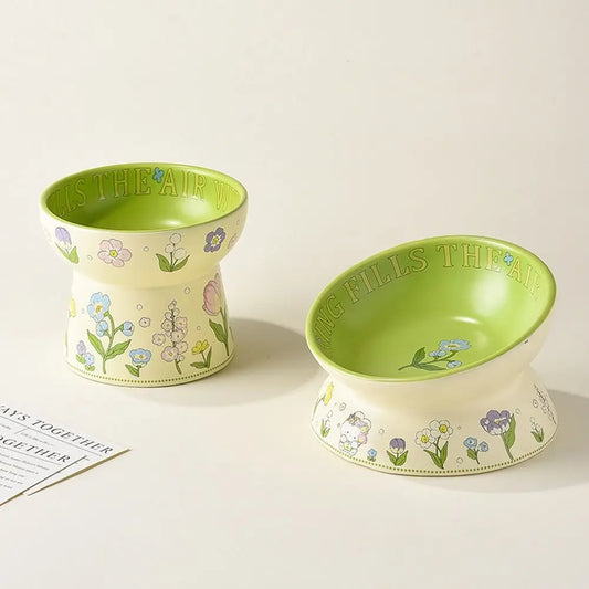 Floral ceramic cat bowls in two shapes on a cream background