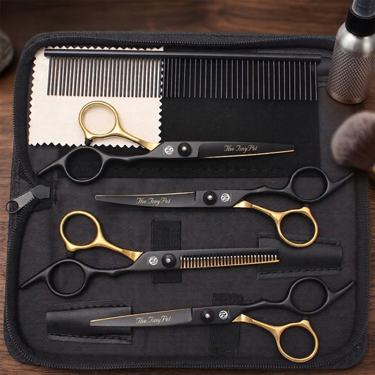 Black and gold grooming scissors set open in its case on a wooden bench