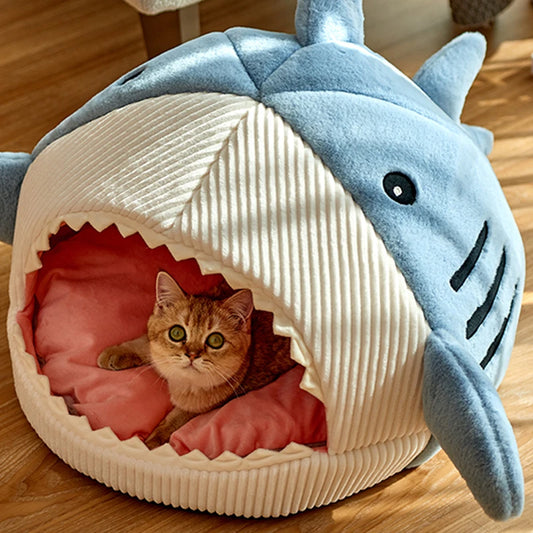 Blue shark cave bed with a ginger cat resting inside on the coral cushion