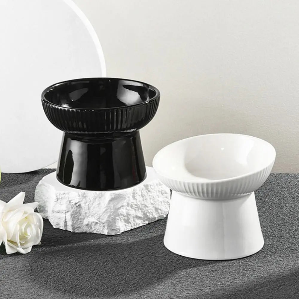 Black and white fluted pedestal bowls on a grey surface