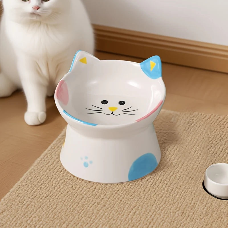 Cat-face bowl with black ears and a red heart beside a white cat
