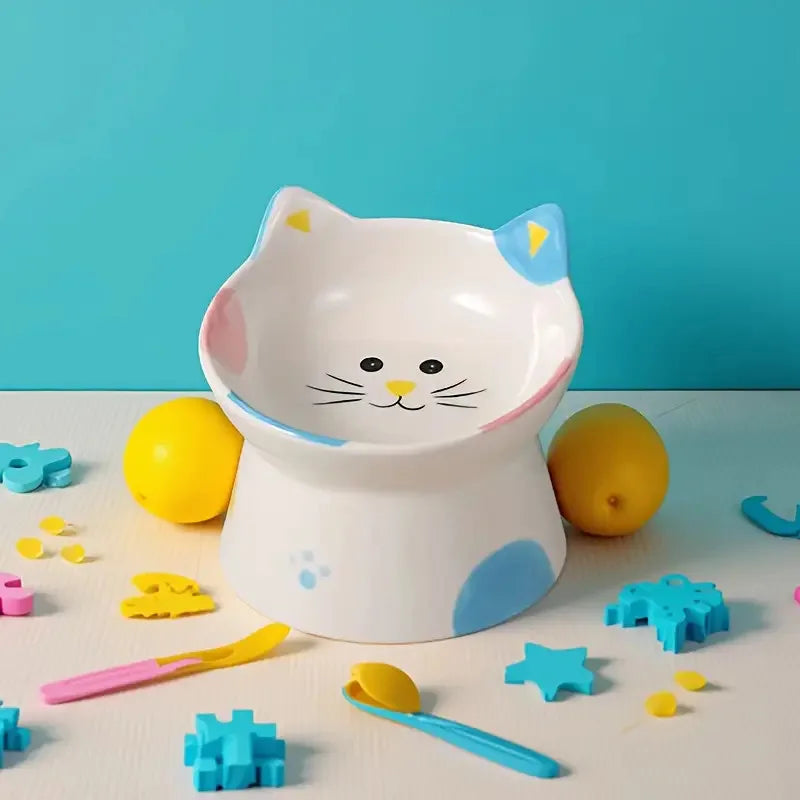 Cat-face bowl photographed with toys around it
