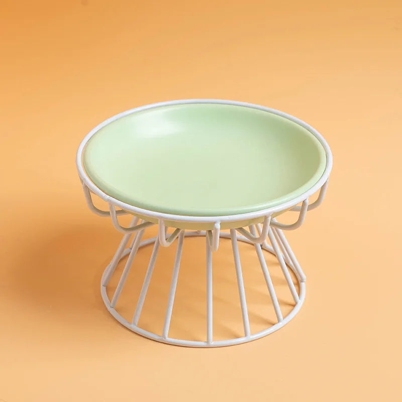 Sage green ceramic plate on a white wire stand