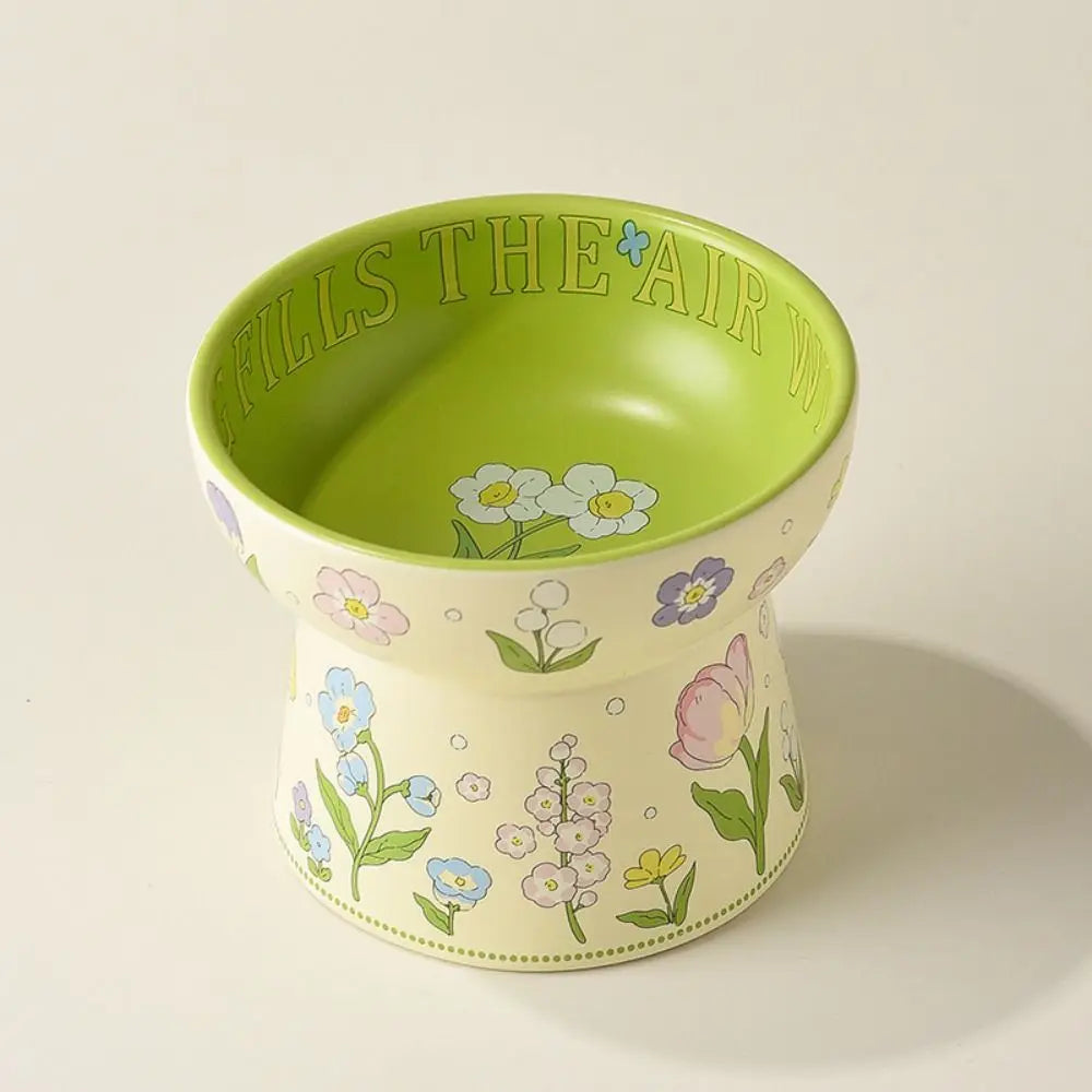 Tall floral ceramic cat bowl with a green interior