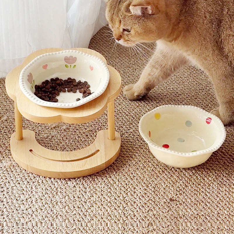Cat approaching a patterned bowl in the wooden stand