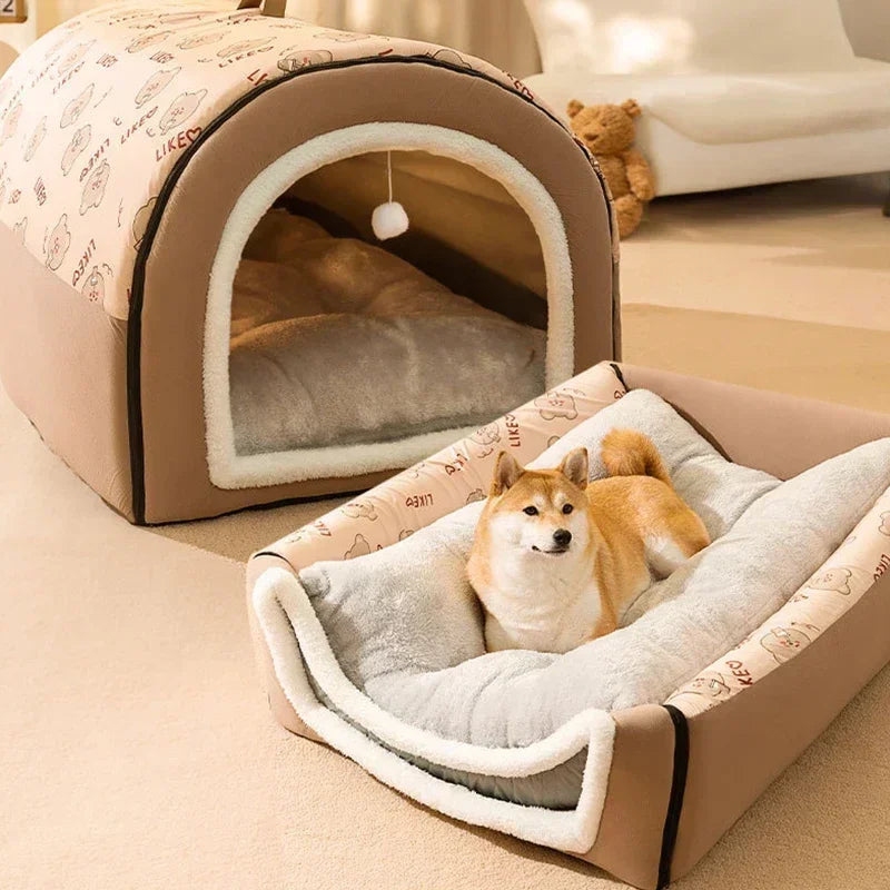 Brown cave-style pet bed with a corgi lying in the open front section, on a wooden floor
