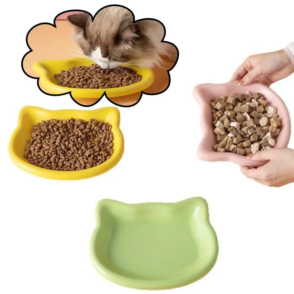 Cat-shaped dishes held in the hand to show the size