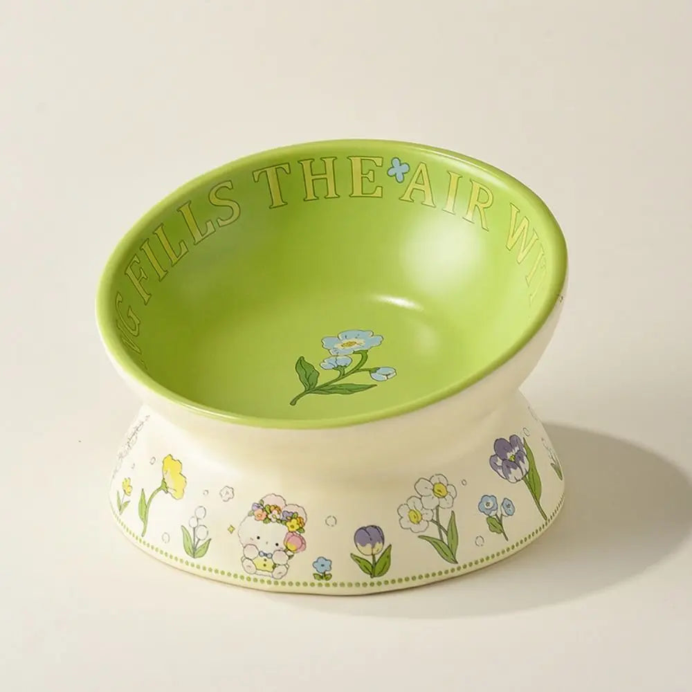 Close-up of the green glaze and painted flowers inside the bowl