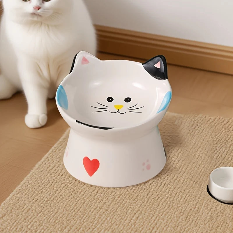 Cat-face bowl on a wooden floor with strawberries