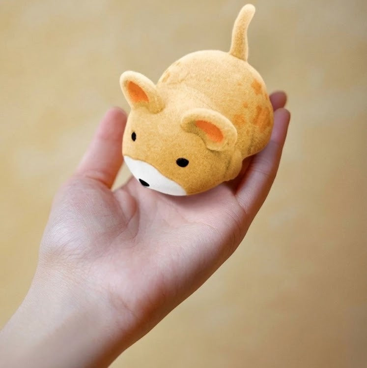 The electric toy mouse held in a hand, about 5 cm long